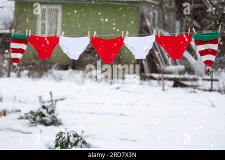 Red and white shorts are hung in the form of a Christmas garland. Stock Photo