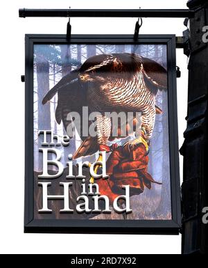 Traditional hanging pub sign at The Bird in the Hand a Marstons public house, Market Place, Leek, Stoke-on-Trent, Staffordshire, England, UK. Stock Photo