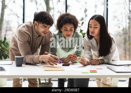 Three Diverse Young Business Professionals Brainstorming Working Together In Office Stock Photo