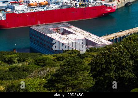 PORTLAND, ENGLAND – JUL 20  2023: Bibby Stockholm barge docked on land after arriving the day before. To house 500 UK asylum seekers. Portland, Weymou Stock Photo