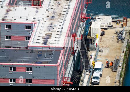 PORTLAND, ENGLAND – JUL 20  2023: Detail of Bibby Stockholm barge from above docked on land after arriving the day before. Being prepared to house 500 Stock Photo