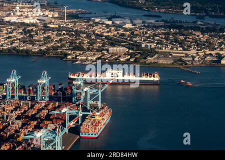 Aerial view of a freighter, cargo containers, Newark Bay, Panamax cranes, and the Port of Newark - Elizabeth Marine Terminal Stock Photo
