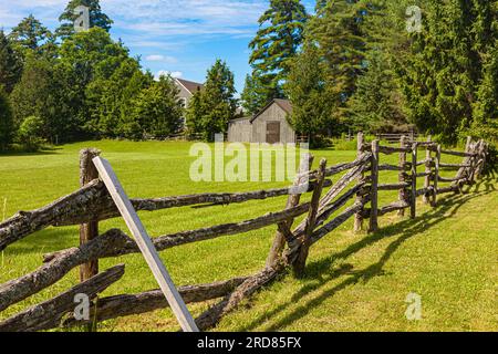Weathered heritage fence with new farm buildings near Sparrow Lake in Muskoka Ontario Canada Stock Photo