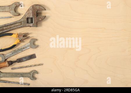 Flat lay composition with old tools on a light wooden background. Top view with various repair tools. The concept of craftsmanship and handicraft, fat Stock Photo