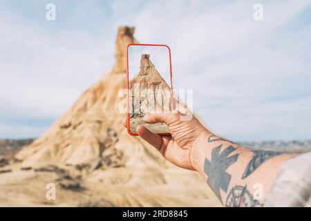 Taking photos with a smartphone of a Castil de Tierra peak, close-up shot Stock Photo