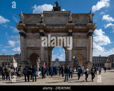 Paris, Île-de-France, France - October 1, 2022: Several Tourists Around the Arc de Triomphe du Carrousel with Statues on Top in Front of the Louvres M Stock Photo