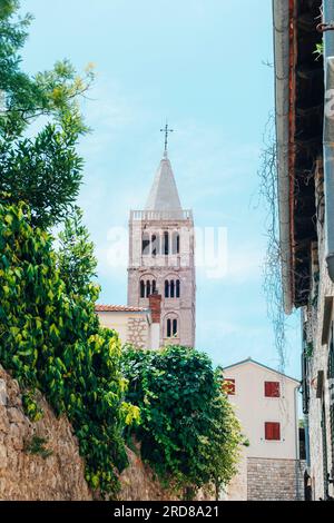 Bell tower of St. Mary's church and narrow street of the old town of Rab on the island Rab, Croatia. Stock Photo