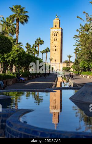 Ancient minaret tower of Koutoubia Mosque, UNESCO World Heritage Site, reflected in a fountain in the formal gardens, Marrakech, Morocco Stock Photo