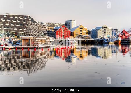 Colorful houses by the harbor mirrored in the cold sea at dawn, Tromso, Norway, Scandinavia, Europe Stock Photo