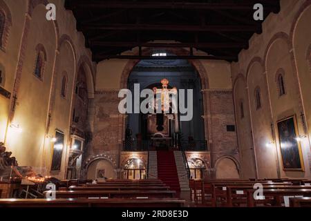 Cross-shaped icon of Jesus hanging inside Santo Stefano religious complex, part of Sette Chiese (The Seven Churches), Bologna, Emilia Romagna, Italy Stock Photo