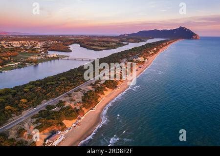 Aerial view of the lake and beach of Sabaudia with the woody mountain of Circeo in the background at dusk, Sabaudia, Tyrrhenian Sea Stock Photo