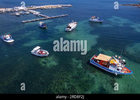 White and blue fishing boats in the water of Marzamemi harbour, Pachino municipality, Siracusa province, Sicily, Italy, Mediterranean, Europe Stock Photo