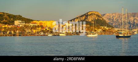 View of boats and colourful buildings at sunset in Golfo Aranci, Sardinia, Italy, Mediterranean, Europe Stock Photo