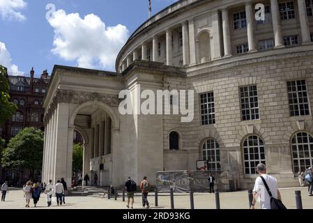 People walk past the Central Library in the Spring sunshine, St Peter's Square, Manchester, UK, library, copy space Stock Photo