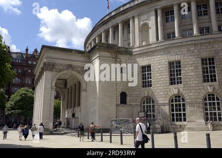 People walk past the Central Library in the Spring sunshine, St Peter's Square, Manchester, UK, library, copy space Stock Photo