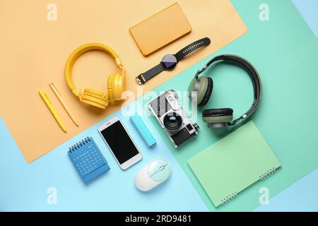Composition with different gadgets and stationery on color background Stock Photo