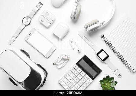 Composition with modern gadgets and notebook on white background Stock Photo