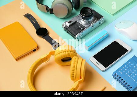 Composition with different gadgets and stationery on color background Stock Photo
