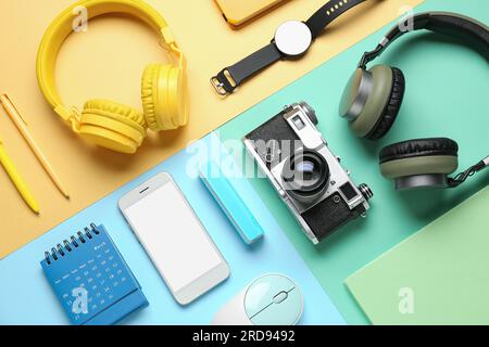 Composition with different gadgets and stationery on color background Stock Photo