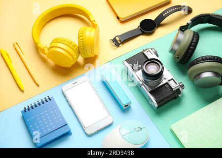 Composition with different gadgets and stationery on color background Stock Photo