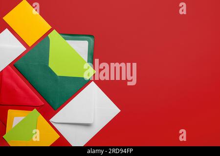 Composition with different envelopes and blank cards on red background Stock Photo