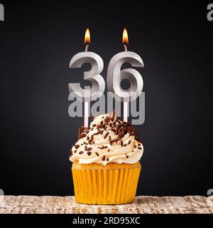 birthday cupcake with number 36 candle - Celebration on dark background Stock Photo