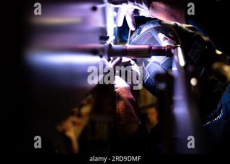230718-N-HA192-1061 ATLANTIC OCEAN (July 18, 2023) Hull Maintenance Technician 2nd Class Marc Paz welds piping onto a newly installed fan coil unit aboard the Wasp-class amphibious assault ship USS Bataan (LHD 5). The U.S. Navy and U.S. Marine Corps routinely participate in scheduled deployments to improve combined combat readiness, increase operational capacity, and strengthen relationships among allies and partners throughout the region. (U.S. Navy photo by Mass Communication Specialist 2nd Class Matthew F. Brown) Stock Photo
