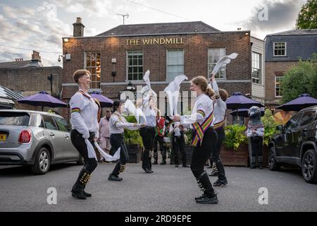 London, UK. 19th July 2023. Brixton Tatterjacks and New Esperance Morris(pictured) dancers perform a dance-out at The Windmill pub on Clapham Common. New Esperance are an inclusive women’s morris dancing team who perform Cotswold dances. Originally formed in 1973 and inspired by Mary Neal's historical Espérance Club girls, who were young women dancers from the turn of 1900. Credit: Guy Corbishley/Alamy Live News Stock Photo