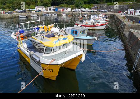 Dunure harbour, Ayrshire on the west coast of Scotland and opening into the Firth of Clyde, with small fishing boats and privately owned pleasure boat Stock Photo