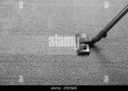 Vacuuming grey carpet. Clean area after using device. Space for text Stock Photo
