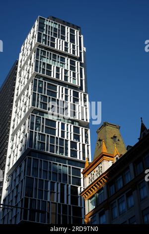 Sydney Architecture, a modern apartment block, One30 Hyde Park towers over the turreted mansard roof of the former Mark Foys now a court house Stock Photo