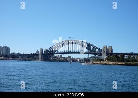 Sydney Harbour Bridge is seen from on the water to the west of Barangaroo, clear blue sky and beautiful blue water Stock Photo