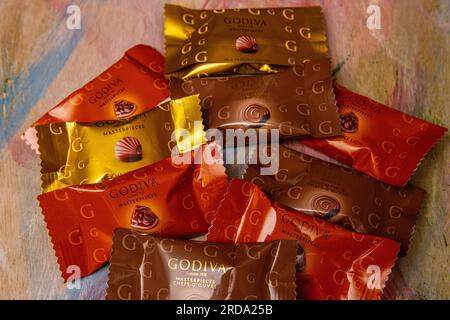 A variety of individually wrapped Godiva chocolates Stock Photo