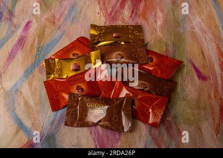 A variety of individually wrapped Godiva chocolates Stock Photo