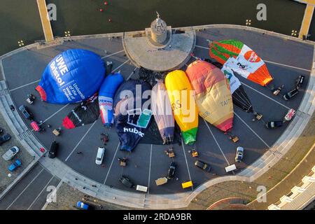 Hot air balloons inflate and tether from Bristol Harbourside in the early morning as the countdown begins to the 2023 Bristol International Balloon Fiesta at Ashton Court Estate in August. Picture date: Thursday July 20, 2023. Stock Photo