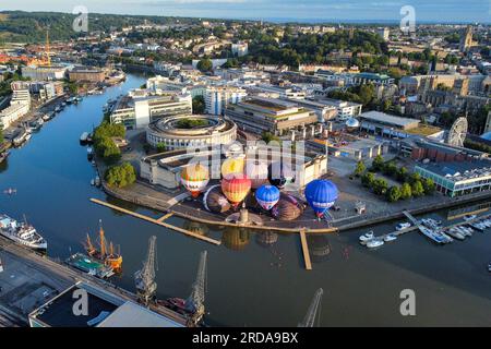 Hot air balloons inflate and tether from Bristol Harbourside in the early morning as the countdown begins to the 2023 Bristol International Balloon Fiesta at Ashton Court Estate in August. Picture date: Thursday July 20, 2023. Stock Photo