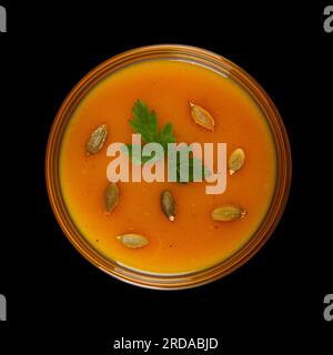 Pumpkin cream soup isolated on black background Stock Photo