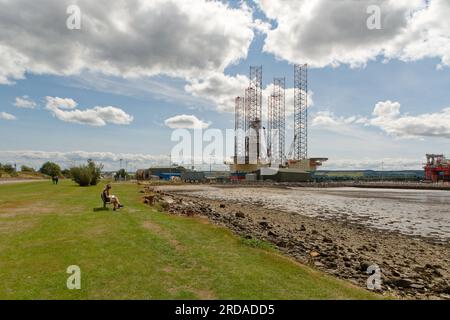 Oil Drilling Platforms under construction at Invergordon on the Cromarty Firth in Scotland. Beautiful day with Blue sky.Oil Platform Constrauction Stock Photo