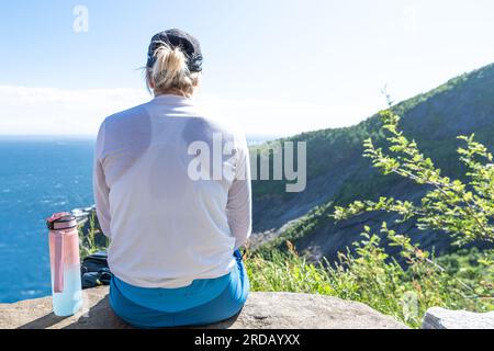 Unrecognizable woman enjoying view from mountains summer. Happy hiker traveler enjoy the view Stock Photo