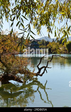 Pagoda on the Black dragon lake in Lijiang surrounded by trees. November 2019 Stock Photo