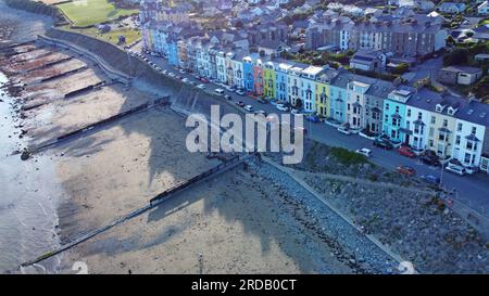 A row of multi coloured painted houses on the seafront in Criccieth, Gwynedd, North Wales, July 2023 Stock Photo