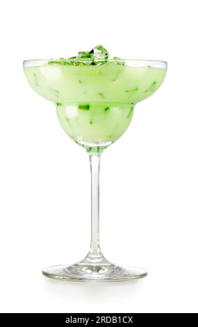 Tasty iced green cocktail served in margarita glass. Studio shot of refreshing alcoholic beverage or matcha latte isolated on white background. Stock Photo