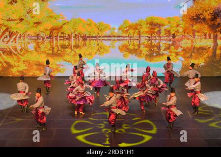 Jakarta, Indonesia. 19th July, 2023. Dancers from China's Xinjiang Art Theater Muqam Art Troupe perform in Taman Ismail Marzuki in Jakarta, Indonesia, July 19, 2023. Dozens of dancers and singers from China's Xinjiang Art Theater Muqam Art Troupe enlivened the stage of Taman Ismail Marzuki, the art center here in Indonesia's capital on Wednesday night.TO GO WITH 'Art troupe from China's Xinjiang enlivens Muslim festival in Indonesian cities' Credit: Xu Qin/Xinhua/Alamy Live News Stock Photo