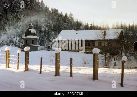 Tarcau Monastery, Neamt County, Romania, 1999. The bell tower and a traditional house serving as monastic lodging. Stock Photo