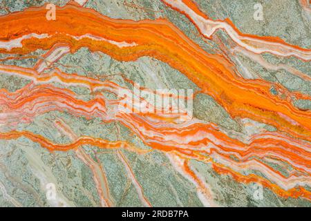The unique texture of Onyx, bright saturated streaks of orange on a gray-green background, similar to rivers Stock Photo