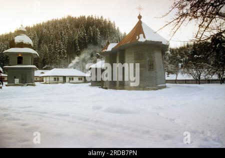Tarcau Monastery, Neamt County, Romania, 1999. Exterior view of the wooden church, built in 1833, and the bell tower, built in 1868. Stock Photo
