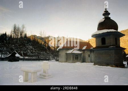 Tarcau Monastery, Neamt County, Romania, 1999. Exterior view of the wooden church, built in 1833, and the bell tower, built in 1868. Stock Photo