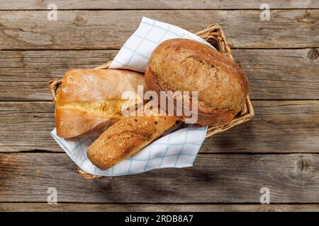 Assorted bread varieties in a charming basket, ready to be enjoyed. Flat lay Stock Photo
