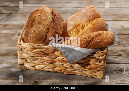Assorted bread varieties in a charming basket, ready to be enjoyed Stock Photo