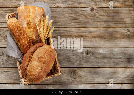 Assorted bread varieties in a charming basket, ready to be enjoyed. Flat lay with copy space Stock Photo